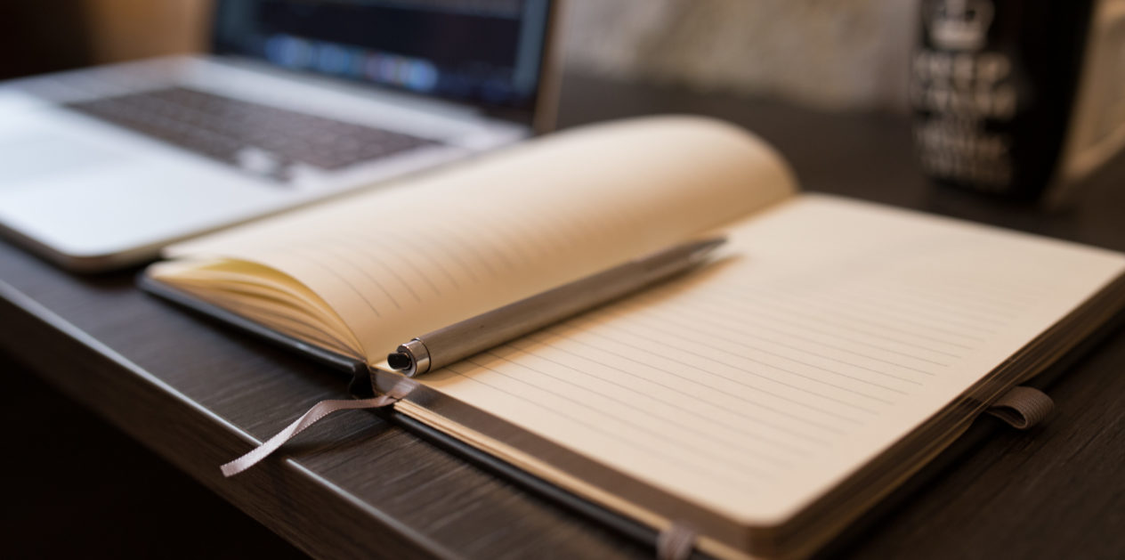 An image of an open book with a pen for research
