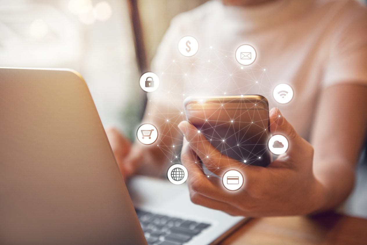 Hand holding smart phone with graphic icon multichannel communication and ecommerce